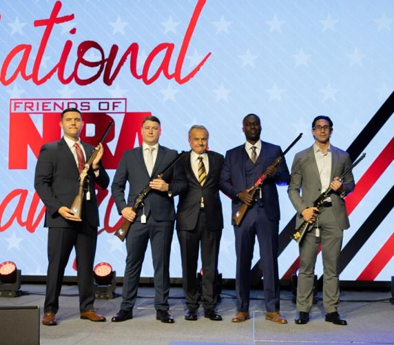 Henry Repeating Arms Founder and CEO Anthony Imperato stands with three Austin Police Department officers honored for their actions in stopping the Sixth Street mass shooter in Austin last month, along with Pasadena hero Juan Lopez, during a special pre...