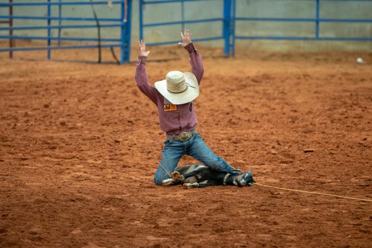 Ketch Burdette tying goats