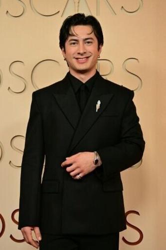 'Heated Rivalry' star Hudson Williams hit the Oscars red carpet