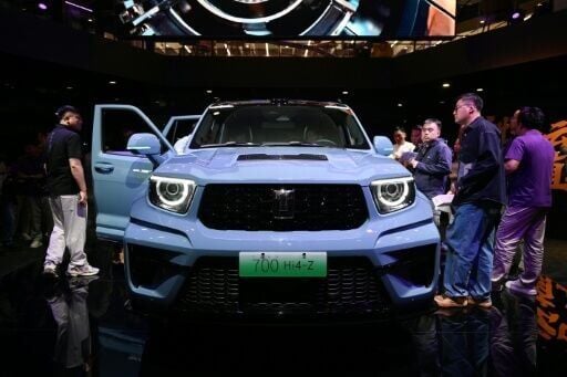 Visitors crowd around a Great Wall Motors sub-brand Tank 700 Hi4-Z at the Beijing Auto Show