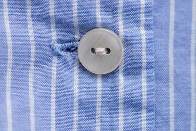 Is the person wearing the clothes fastening their own buttons?