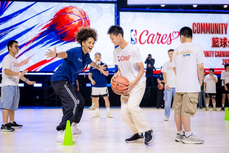 An NBA coach leads a basketball clinic, guiding a group of MSO members through basketball skills training at the Community Basketball Carnival during the Impact Week. Through demonstrations and personalized instruction, she helped participants enhance t...