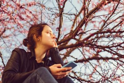 Unhappy woman outside sitting thoughtfully