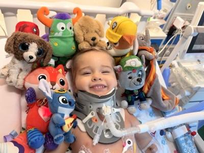 Oliver Staub, 2, smiles while recovering from two complex spinal cord surgeries at UChicago Medicine Comer Children's Hospital that reattached his head to his spinal cord.