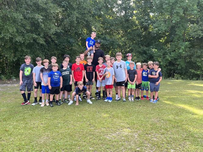 Edgewood Academy's Wanogho Jr. visits EA youth football camp
