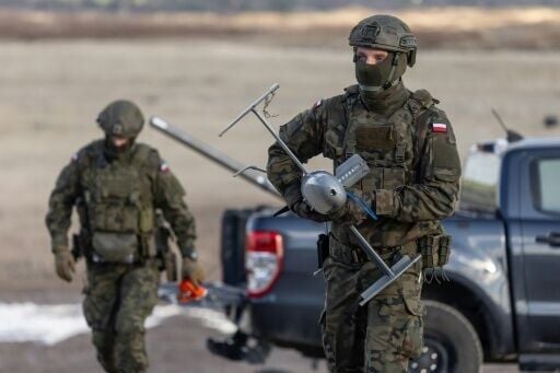 A Polish soldier carries an interception drone during tests in the southeast of the country in November