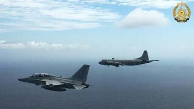 This handout photo taken on February 26, 2026 and released on February 27 by the Armed Forces of the Philippines-Public Affairs Office (AFP-PAO) shows a Philippine air force FA-50 fighter jet (L) flying alongside a Japan Maritime Self-Defence Force's P-...