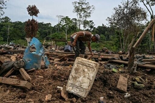 Farmer Jose Pena looks for belongings amid rubble after a bomb dropped by the Ecuadoran army in the Lago Agrio region of Ecuador on the border with Colombia