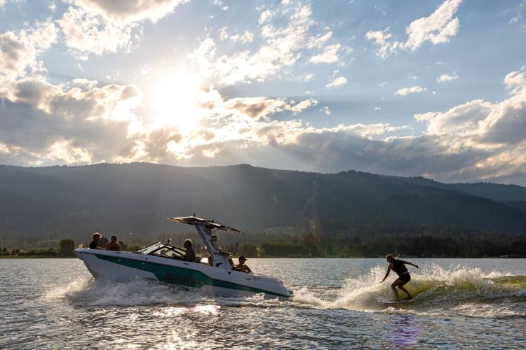 Boaters enjoy surfing on Lake Cascade near the Tamarack Resort Marina.