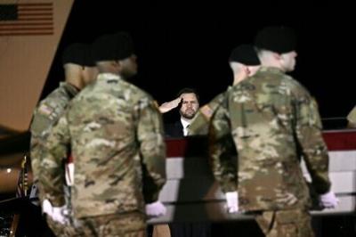 US Vice President JD Vance salutes as members of a US Army team carry a flagged-drapped transfer case containing the remains of Sgt. Benjamin N. Pennington, 26 during a dignified transfer event at Dover Air Force Base