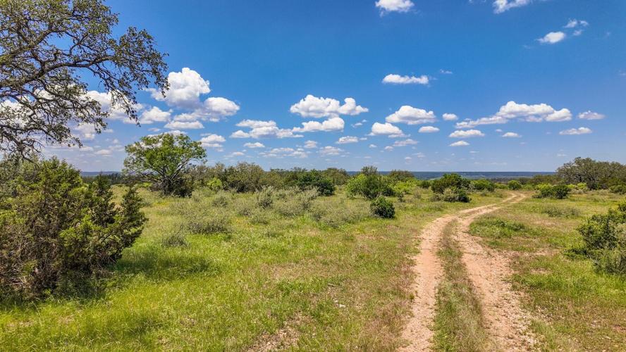 The property’s wooded setting and panoramic Hill Country views give buyers a place to plan a country home or retreat while staying connected to the surrounding area.