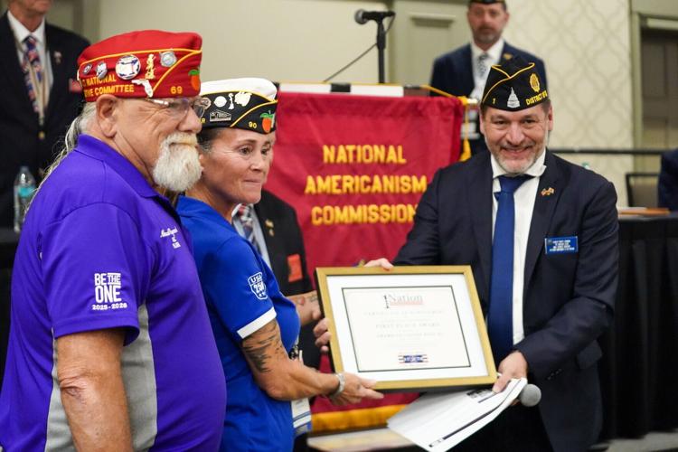 Accepting the award on behalf of 1st Place Post 103 Punta Gorda, The American Legion Department of Florida, are Past District Commander Michael "Gambler" Raymond (left) and District 13 Commander Laurene Flower. 1Nation President Charles Fowler (right) p...