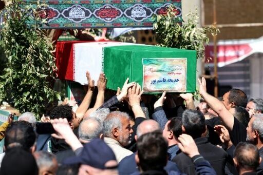 Mourners carry a coffin draped in an Iranian flag during a funeral in Tehran