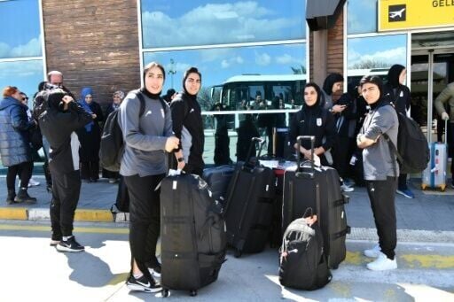 Members of Iran's women's football team at Igdir airport in Turkey, waiting for a bus to take them to the Iranian border