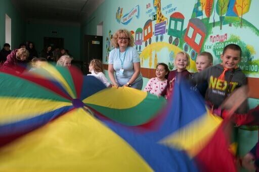 Psychologist Maryna Dudnyk (centre) working with a group of children in Khorosheve, Ukraine