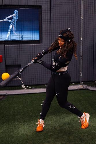 Texas softball athlete Kayden Henry demonstrates motion capture technology, just one of many tools that can be used to maximize human performance through data analysis in Bevo Lab.