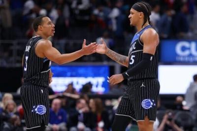 Desmond Bane, left, scored 22 points and Paolo Banchero, right, added 18 for the Orlando Magic in an NBA playoff victory over Detroit