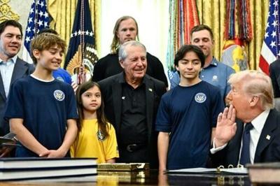 US President Donald Trump was surrounded by children as he signed a proclamation to revive the Presidential Fitness Test Award