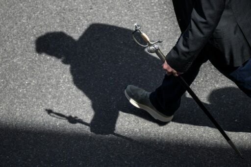 A citizen holds his sword as he walks to attend the Landsgemeinde in Appenzell