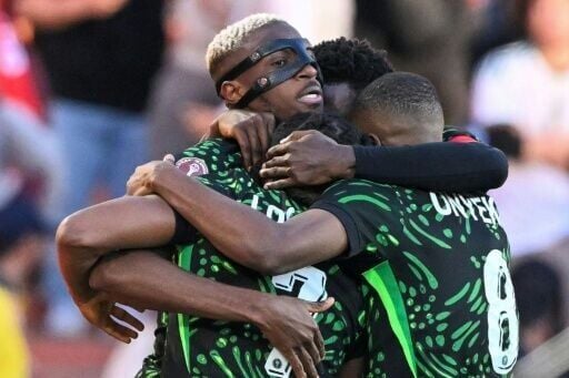 The masked Victor Osimhen celebrates with teammates as Nigeria beat Algeria to set up a semi-final against hosts Morocco