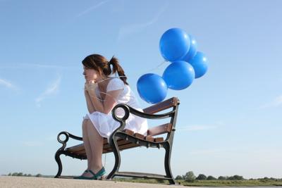 A portrait of a girl sitting on a bench, deep in contemplation.