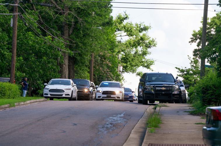 Alexander City police officers work the scene of a shooting on N street