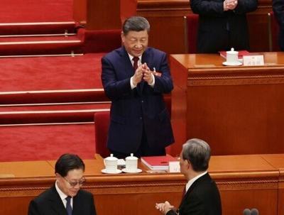 Chinese President Xi Jinping applauds during the closing session of the National People's Congress (NPC) at the Great Hall of the People in Beijing on March 12, 2026