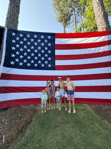 MASSIVE American flag with kids.jpeg