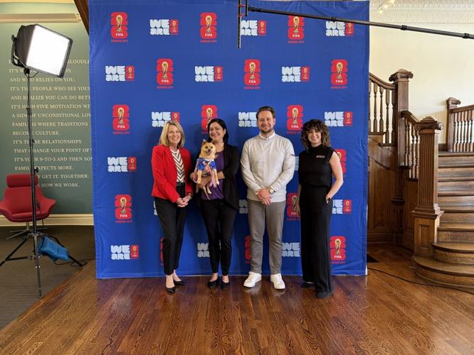 Representatives from Purina and KC2026 gather with Keeper, a 7-year-old mixed-breed dog available for adoption through KC Pet Project, after announcing Dog Days at FIFA Fan Festival™ in Kansas City, Mo., on May 12, 2026. Pictured from left are Pam Krame...