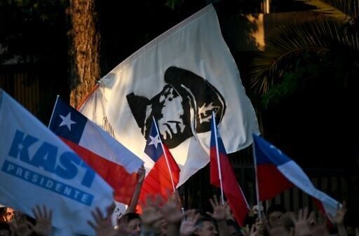 Supporters of Chile's presidential candidate Jose Antonio Kast, of the Partido Republicano party, wave a flag depicting late military dictator Augusto Pinochet