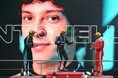 Winner Mercedes' Italian driver Kimi Antonelli (C), second-placed Mercedes' British driver George Russell (L) and third-placed Ferrari's British driver Lewis Hamilton (R) celebrate on the poidum after the Formula One Chinese Grand Prix at the Shanghai I...