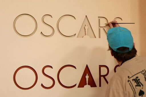 Workers are putting the finishing touches on the red carpet for the Oscars gala in Hollywood