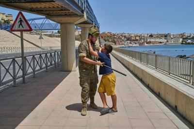 A 12-year-old unaccompanied minor who crossed into Spain on Aug. 3, 2026, is escorted by a Spanish soldier to the Spain-Morocco border as the child begs not to be sent back to Morocco.