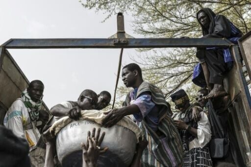 Baye Fall followers load food for iftar meals into a truck in Touba, Senegal on March 1, 2026