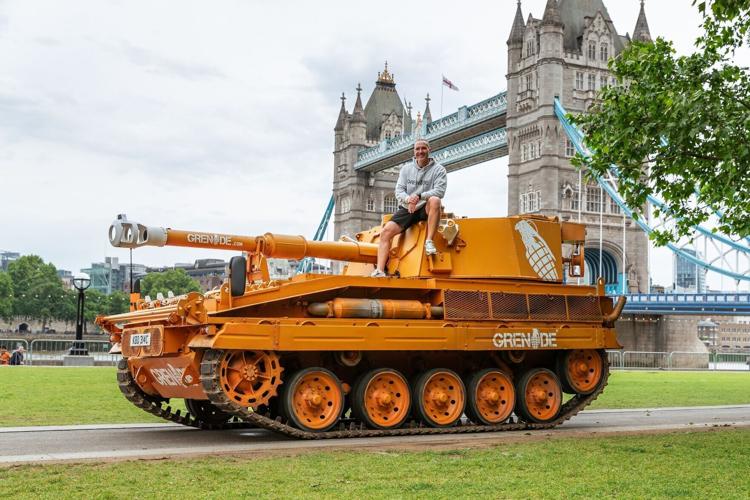 Grenade staged a publicity stunt in London in 2025 by driving a 17-tonne tank through a giant 13-foot carbohydrate and sugar "wall" near Tower Bridge. Grenade co-founder Alan Barratt sits atop a tank.