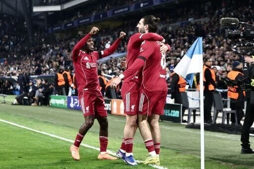 Liverpool players celebrate after Dominik Szoboszlai (R) gave them the lead in Marseille