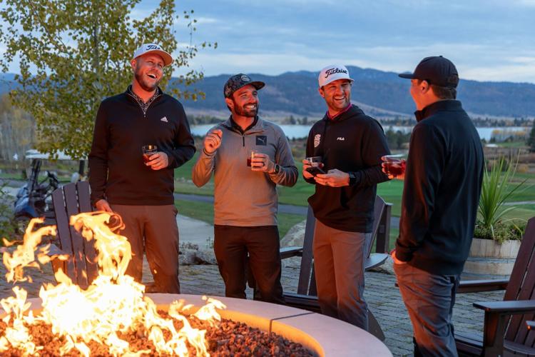 Friends enjoy drinks by the fireside after playing 18 holes of golf at Tamarack Resort's Osprey Meadows Golf Course.