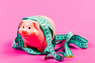Economics and finances. Pig trap. Budget crisis. Planning budget. Business problem. Limited or restricted. Piggy bank and measuring tape. Budget limit concept. Credit loan debt. Financial consulting