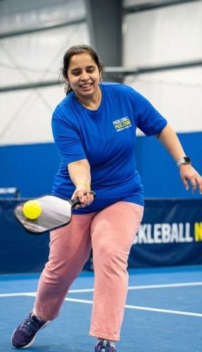 Vidya R. takes to the court, embodying the spirit and excitement of pickleball.