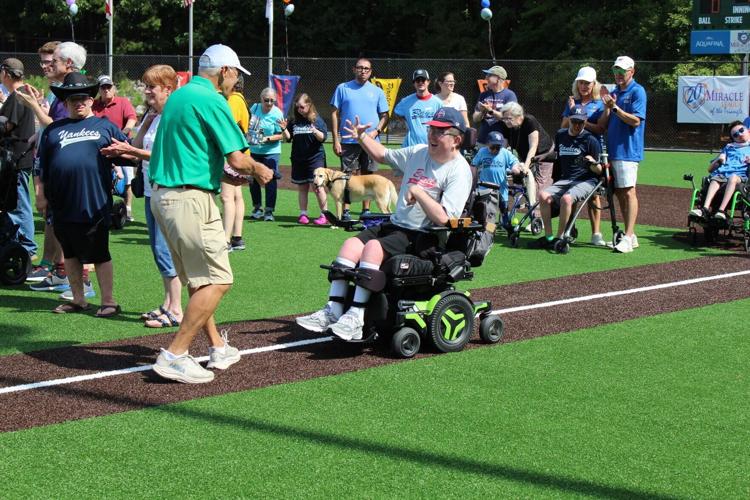 Miracle League of the Triangle Co-Founder Tony Withers with 20-Year Player Bryson Dew