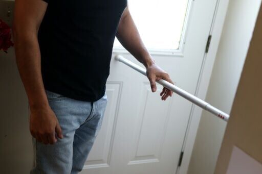 A metal bar braces the door to the home of a Mexican family in Minneapolis that has gone into hiding due to immigration raids in their city