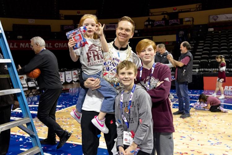 FHU Head Coach Drew Stutts and his children celebrate the team's NAIA National Championship win Tuesday, March 24, 2026, in Kansas City, Missouri.