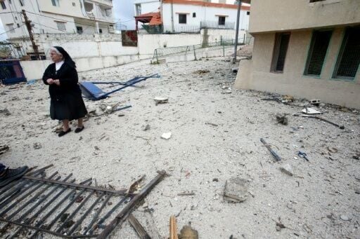 Sister Maria Wehbe stands in the damaged courtyard of the Antonine nuns school in the southern Lebanese city of Nabatieh