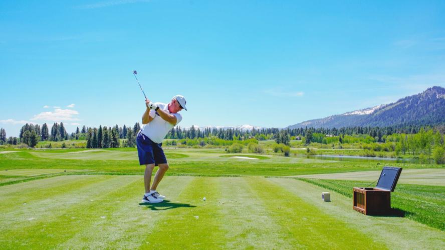 A golfer practices his swing while enjoying May sunshine at Osprey Meadows Golf Course.