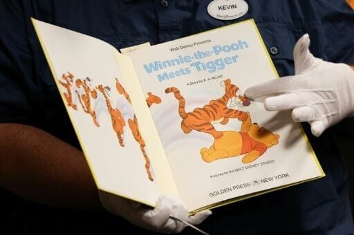 A member of the Walt Disney Studios Archive staff displays a vintage Winnie the Pooh book