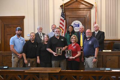 Cliff Williams / TPI Ken Carter, center, was selected as the volunteer among county EMAs across Alabama. He not only volunteers at the Elmore County EMA but also the Titus Volunteer Fire Department and at Ft. Toulouse / Ft. Jackson.