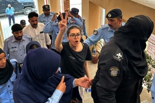 Police take human rights activist Imaan Mazari to a court in Islamabad on August 20, 2023