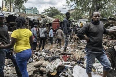People survey the damage and try to salvage what they can after heavy flooding in the Kenyan capital