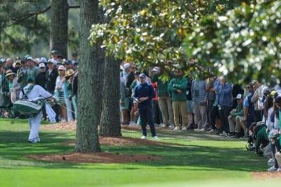 Defending champion Rory McIlroy found himself under the trees often in the first round of the 90th Masters, missing five of 14 fairways, but still fired a 67 to share the lead at Augusta National
