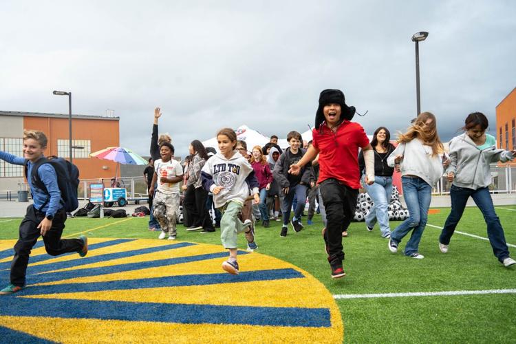 Students run onto the new synthetic turf field at Willie L. Brown Jr. Middle School in San Francisco, part of a $1.9 million effort by Playing for Keeps Foundation and America SCORES Bay Area to create or upgrade play spaces at 14 San Francisco schools.